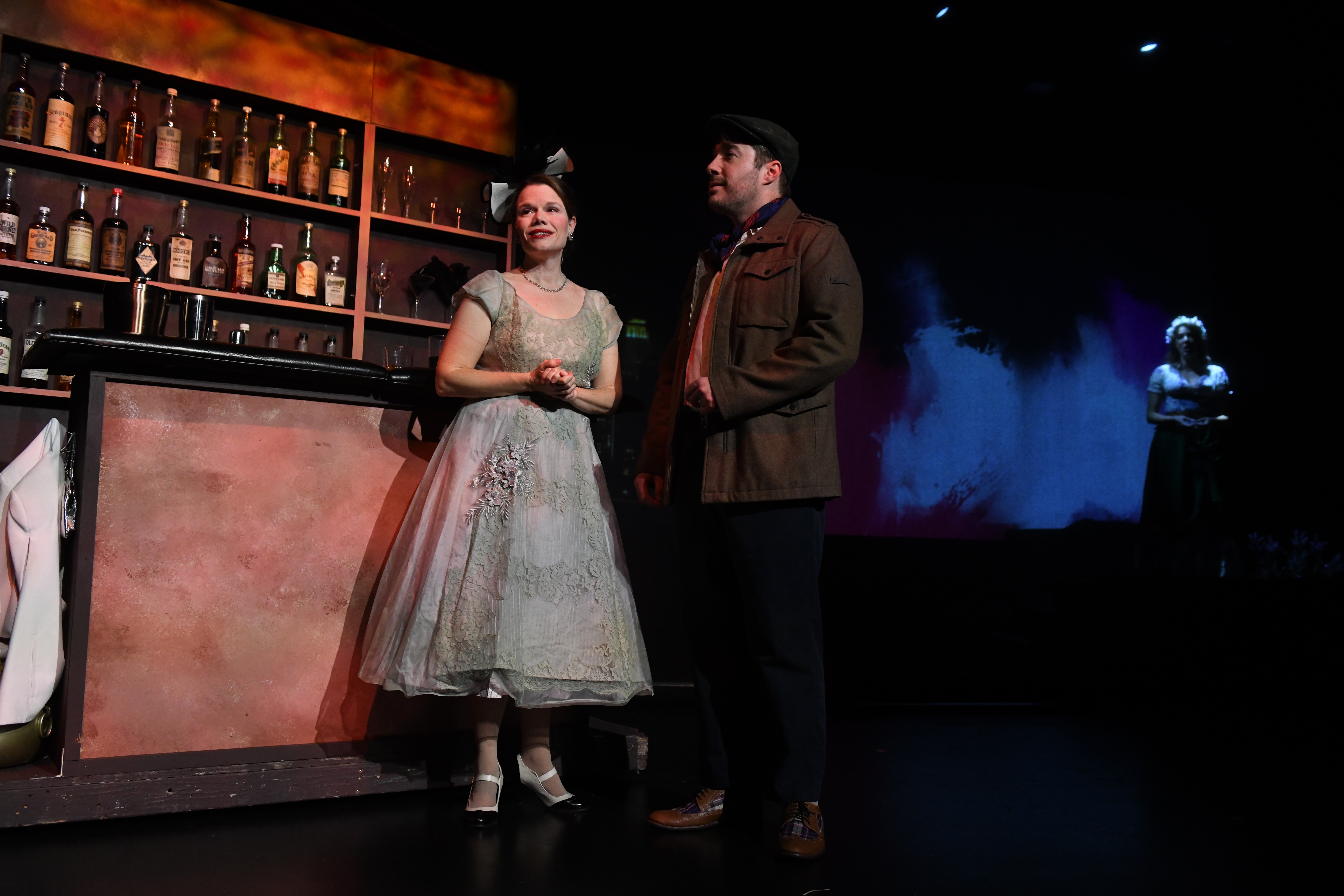 a couple in front of a bar